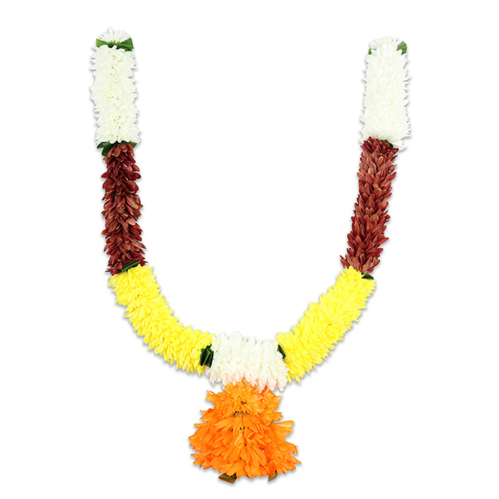 This ornamental U-shaped garland hangs like an offering, its layered construction and warm palette immediately suggestive of traditional Indian torans used for auspicious entrances. The top of each arm begins in a compact column of creamy white, cushiony florets that catch the light and read like tiny chrysanthemums or closely packed carnations, creating a soft, luminous rim. Directly beneath, each arm switches to a concentrated band of deep reddish-brown - a textured, flattened petal effect that resembles dried leaf clusters or mahogany-toned fabric, lending the piece an earthy counterpoint. The design curves into a broad sweep of bright yellow that forms the main body of the U: these yellow elements are densely arranged, fluffy and marigold-like, producing a full, tactile band evocative of festival garlands hung during Diwali, Ganesh Chaturthi, Onam or Pongal. At the very centre where the two curves meet, a prominent orange pendant hangs - a round, multi-layered cluster of ruffled petals whose vibrant hue creates a joyful focal point and visual rhythm. Tiny bright green accents appear at the colour joins like delicate leaves or stitched separators, offering relief and definition. The artificial materials - fine silk-like fabric and soft foam cores - are threaded tightly for longevity, designed to withstand repeated ceremonial use and to be a lasting source of colour on a doorway or shrine. I picture this toran brightening entries across Queensbury and the surrounding neighbourhoods, a festive, welcoming piece that balances celebration with devotion.