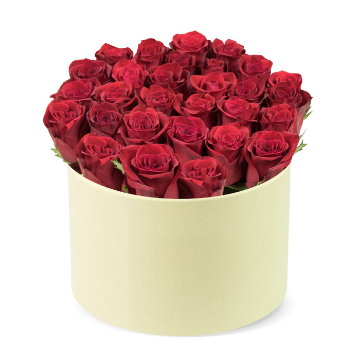 An exquisite boxed bouquet, two dozen or more red roses with velvety, deeply crimson petals, tightly furled in prime bloom. They are arranged in a round, elegant cylindrical box in pale cream, its matte finish providing a sophisticated frame for the blooms. The roses fill the container fully, creating a slightly domed crown that rises above the rim, while subtle dark green foliage peeks between heads, adding depth and a touch of forest freshness. The container itself is understated and luxurious, a smooth ivory box that makes the red glow sing, set against a clean white background to isolate the composition and emphasize craftsmanship. This boxed bouquet carries romance and prestige, suitable for Valentine's Day, anniversaries, or celebratory moments. Its hat-box-inspired packaging nods to classic floristry while embracing a modern, fashion-forward sensibility. Delivered by Flower Delivery Queensbury to homes along the High Street and nearby streets, it offers a reliable option for same-day arrival wherever you are in Queensbury. The arrangement invites quiet admiration, with a perfume-like scent of the roses, a soft texture of the petals, and careful hand-placement all testifying to a dedicated local florist's craft. It's a refined gift that communicates love with quiet confidence, ideal for readers exploring premium flower delivery in our part of London.