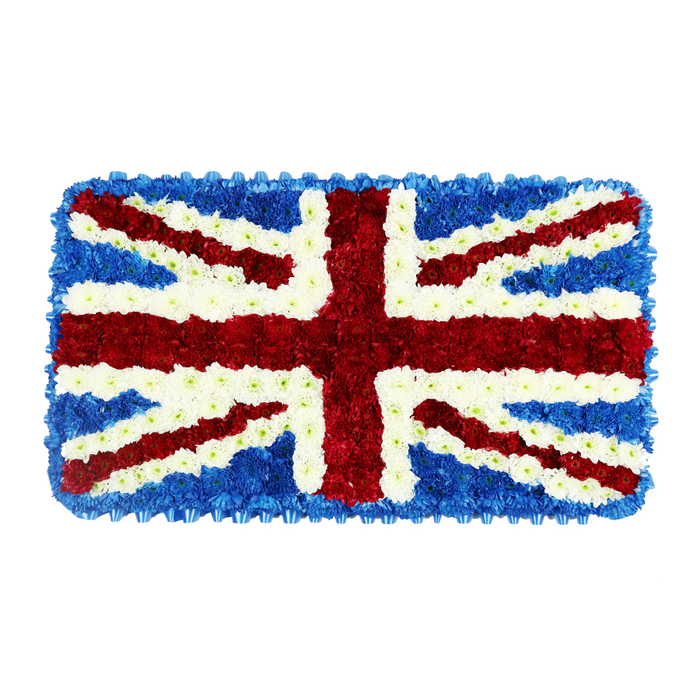 In this image, a large rectangular floral arrangement faithfully recreates the Union Jack, designed as a funeral or memorial tribute with meticulous attention to every detail. The flag appears almost three-dimensional due to the dense layering of small blossoms, each head nestled tightly into the next so that no gaps or stems are visible. At the heart of the design, a strong red cross representing St George runs vertically and horizontally, formed from deep red flowers whose ruffled petals lend a rich texture. The diagonal red lines of St Patrick's Cross intersect with equal precision, their edges kept crisp by narrow bands of white flowers that frame and separate the colours. These white sections also widen into the broader diagonals of St Andrew's Cross, fanning out from corner to corner in clean, snowy streaks. Behind and around all of this, intense blue flowers, possibly hydrangeas or well-packed chrysanthemums, create a smooth, even background that anchors the composition. The outer edge of the arrangement is neatly squared off, giving the tribute a formal, almost ceremonial presence often requested for services in Queensbury and surrounding areas. One can imagine it displayed at the front of a chapel, perhaps during a service for someone who served in the forces or simply loved their British heritage while living off Kenton Road or near Queensbury Park. The lighting in the image is bright but gentle, highlighting the texture and depth of the flowers without casting harsh shadows, and the overall effect is both dignified and comforting-a floral flag that expresses loyalty, remembrance, and quiet pride all at once.