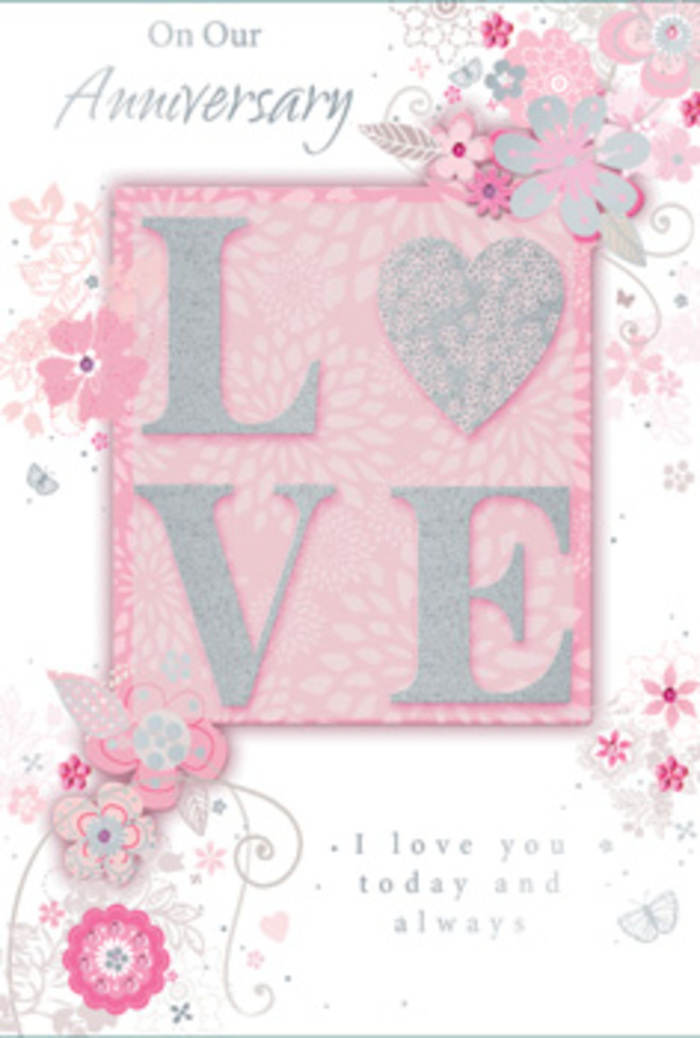 This photograph captures an anniversary card that looks as if it has been designed by someone who understands both flowers and feelings, much like a local Queensbury florist preparing a bespoke arrangement for a long-married couple. The card's main focus is the word LOVE, centred and slightly raised, each letter filled with blush pink and kissed with a dusting of fine, frosted glitter. The glitter is not overpowering; instead, it gives a soft, romantic sparkle, reminiscent of early sunlight glinting off dewy petals in a back garden near Queensbury station. Around this central word, a graceful composition of hand-drawn flowers, tender leaves, and curling stems unfolds. The blooms are stylised rather than realistic, but their flowing petals, shaded in tones of pink, ivory, and soft dove grey, suggest the shape of roses, anemones, and tiny filler blossoms you might find in an anniversary bouquet. Some fine elements gleam with subtle silver foil accents, adding depth and a hint of celebration without overwhelming the calm design. The background is a gentle wash of pastel pink, softening to almost white toward the edges and creating a dreamy, airy border. Nestled among the florals and towards the lower part of the card is a graceful message printed in an elegant script, speaking of love that lasts, of shared days and future hopes. The overall effect is tranquil, romantic, and quietly luxurious-like receiving a thoughtfully arranged bouquet delivered across Queensbury, where every stem and every sentiment has been carefully considered.