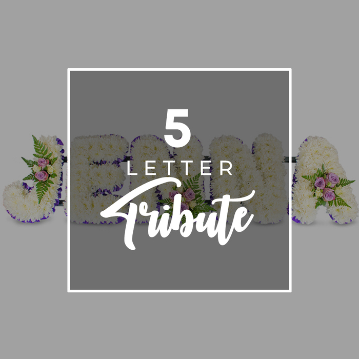 A carefully photographed five-letter funeral tribute is displayed across a smooth, muted grey background, capturing the fine details of the floristry. Each letter is formed from a sturdy frame and completely blanketed in compact white chrysanthemums or carnations, their small blossoms pressed closely together to create a seamless, velvety surface. The white flowers catch the gentle, even lighting, giving the arrangement a soft radiance that feels tender rather than stark. Along the outer contour of every letter runs a border of deep purple satin ribbon, its rich colour and subtle sheen crisply defining the shapes and lending a sense of traditional, respectful elegance. Interspersed among the white petals are modest accent clusters: pale pink and lilac-toned spray roses, their buds and open blooms nestled amid light, feathery fronds of green fern and other foliage, providing a delicate contrast and drawing the eye to key points within the design. The letters that can be seen form a J on the left, followed by portions of O, H, and N behind a central graphic, with an A on the right, illustrating how a loved one's name or an important word can be spelled out in full. Across the centre of the tribute sits a square overlay in a slightly darker grey, outlined in clean white and printed with the words 5 LETTER in crisp capitals above the word Tribute in an elegant white script, clearly describing the style of arrangement. The image conveys quiet reverence and personalised care, much like the bespoke memorial pieces often requested by families in Queensbury who wish their floral letters to carry both beauty and meaning at a final goodbye.