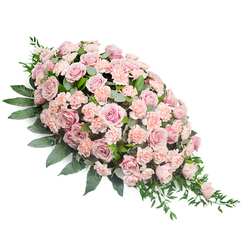 An elongated sympathy spray in soft pink tones is displayed on a clean white background, forming a classic teardrop that is full and rounded at the top left and delicately tapered at the lower right. The heart of the design is a generous cluster of blush and pale rose-pink roses, their petals unfolding in spirals that suggest tenderness and enduring affection. Interwoven between the roses are light peach-pink carnations, each bloom with finely ruffled edges that lend subtle movement and depth, like gentle ripples on still water. Surrounding this pastel centre, lush dark green foliage spreads outward and underneath, creating a rich contrast that frames the flowers without overpowering their softness. The leaves vary from broad, smooth, and slightly glossy to slender, pointed sprigs that reach out and trail along the edge, giving the spray a flowing, almost river-like grace. The composition feels carefully balanced and reassuring, reminiscent of a quiet moment of reflection near the open spaces around Queensbury tube station or a peaceful corner of a local churchyard. Soft, even lighting allows each bloom to be clearly defined, so the viewer can almost imagine the faint, sweet scent of fresh roses and carnations. Crafted as a respectful funeral tribute, the spray is designed to rest along a casket or memorial display, offering comfort and a visual expression of sympathy to families in Queensbury who wish to honour a loved one with calm, timeless beauty.