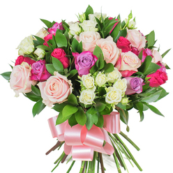 A richly coloured, densely packed bouquet of mixed roses presented against a clean white background, arranged to feel intimate and abundant. The larger roses dominate the view with creamy white and soft blush-pink blooms, some fully unfurled to reveal delicate, paper-thin layers, others kept in poised bud form for contrast. Bold magenta-fuchsia roses are scattered through the massing, giving lively sparks of colour, while a few pale lavender roses cool and soften the overall tone. Tiny spray roses-predominantly ivory with whispers of pale yellow-are tucked into crevices, offering a lovely textural counterpoint to the grander heads and deepening the bouquet's dimensionality. Deep green, glossy foliage, likely ruscus or salal, threads through the arrangement; their elongated, reflective leaves create sculptural lines and a verdant backdrop that makes each petal colour sing. At the base, the stems are neatly gathered and secured with a wide baby-pink satin ribbon tied into a flowing bow whose lustre complements the petals' softness. There is an almost audible hush to this bouquet: the soft rustle of ribbon, the faint, classic scent of roses, and the visual promise of celebration. It's the kind of arrangement we prepare at Flower Delivery Queensbury for special moments-Mother's Day tokens, anniversary surprises, or to say thank you across Queensbury and nearby Wembley-carefully composed to convey warmth, elegance, and sincere affection.