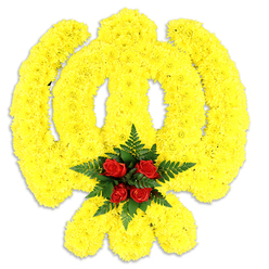 A meticulously constructed floral Khanda occupies the frame, every element chosen to honour tradition with gentle floral artistry. Bright yellow chrysanthemum heads are packed so closely they form a continuous, sunlit surface outlining the circular chakkar, the upright khanda blade and the two crossed kirpans; the tiny ruffled petals give the emblem a plush, tactile quality that reads as soft yet defined. Nestled at the centre, a tight cluster of five to six deep red roses anchors the design - their denser, velvety petals offering a poignant contrast and a focal point of quiet dignity. Around those roses, lush dark green fern fronds are arranged like a protective halo, the fine, serrated leaves framing the red and enhancing the symbolic heart of the piece. The arrangement rests against a pure white background with a soft grey shadow cast beneath it, indicating a substantial, freestanding tribute intended for placement on a lectern, altar or wreath stand at a local Gurdwara or memorial service. The scent is gentle: a warm, honeyed chrysanthemum note softened by the green forest-like freshness of the ferns and the darker, almost tea-like perfume of the roses. Crafted with care for ceremonials across Queensbury, Kingsbury and Wembley Park, this composition reflects the kind of thoughtful work our community values; Flower Delivery Queensbury regularly assembles similar emblems for faith-based events and remembrance, matching colour and proportion to suit the space. The overall effect is respectful and uplifting - a traditional symbol rendered with contemporary floristry skill, intended to comfort and commemorate.
