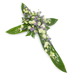 A graceful sympathy cross arranged on a stark white field and photographed from a slightly elevated viewpoint so every arm and the central cluster are visible and balanced. The cross is constructed from large, lustrous green tropical leaves - their smooth surfaces and veins creating a deep, structural green canvas - upon which a generous selection of pale blooms rests. Creamy white lisianthus, their layered, ruffled petals and tender closed buds, form the principal floral voice, supported by clusters of small white chrysanthemum-like blooms that brighten and give body. Tiny, powdery-lilac sprays of limonium or small asters are woven through the central mass and along the arms to introduce a calm purple accent, while delicate filler foliage softens edges and enhances the natural flow. The overall impression is one of composed solace: the tactile sheen of the leaves contrasts with the soft, almost downy petals, and the scent is faintly green with a whisper of floral sweetness. A subtle local note - perfect for delivery across Queensbury and nearby Wembley or Kingsbury - this cross is suited to church services, funeral chapels, or a quiet graveside ceremony. As a florist in the area I prepared it to offer dignified remembrance, its colour palette and symbolic cross shape communicating faith, peace, and heartfelt condolence. Flower Delivery Queensbury often recommends this style for families seeking a traditional, understated tribute that honours both memory and grace.