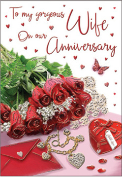 This anniversary card design unfolds like a private love letter styled by a Queensbury florist, intimate and richly detailed. A posy of crimson red roses forms the focal point, each bloom full and velvety, their swirling petals almost three-dimensional as they tilt slightly toward the light. Around them, fresh green foliage adds depth and contrast, making the roses glow even more intensely against the soft, neutral background. Resting beside the flowers is a carefully positioned envelope, hinting at a heartfelt message tucked within, its edges catching a gentle sheen as though placed near a bright kitchen window off Honeypot Lane. A small scarlet jewellery box tied with ribbon, a delicate heart-shaped necklace, and a few sparkling trinkets are thoughtfully scattered nearby, suggesting treasured anniversary gifts exchanged with quiet excitement. Fine red hearts cascade across the surface of the card, some printed, some appearing almost like confetti, guiding the eye toward the flowing anniversary script at the centre. Soft, diffused lighting wraps everything in a warm glow, giving the entire composition a tender, lived-in feeling, as though it's been set down for a moment on a coffee table in a cosy Queensbury home. The scene blends art and emotion: rich reds, gentle highlights, and touches of metallic shine combine to tell a story of enduring devotion, of years marked by shared dinners, walks through local parks, and small but precious surprises. The overall effect is intimate, romantic, and timeless, perfectly suited to celebrate a marriage that still feels like a love story.