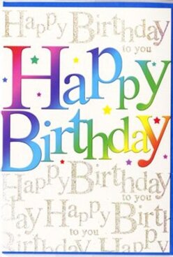 This birthday card radiates the same festive energy you might feel walking past a decorated hall before a party in Queensbury. Dominating the front are large, smooth letters that spell out "Happy Birthday" in a continuous gradient of colour, sliding effortlessly from rich crimson and magenta into cool blues, fresh greens, and finally bright, sunlit yellows. Each letter appears crisply printed and gently glossy, giving the illusion they might almost lift off the card like helium balloons. In the background, a veil of delicate golden handwriting repeats "Happy Birthday to you" in looping script, layered so that the words create a soft, shimmering texture rather than a single readable line. The gold ink reflects the light with a subtle glint, reminiscent of early evening sunlight catching on windows along Honeypot Lane. Tiny, scattered specks and star-like shapes in assorted colours float between the main letters and the background script, echoing confetti swirling in the air after a toast. The composition is carefully balanced: the rainbow message feels bold and youthful, while the gold script adds a note of elegance that would appeal to adults as much as children. You can almost imagine this card propped beside a bright birthday bouquet from a local Queensbury florist, its colours echoing vivid petals and ribbons. The mood is optimistic and celebratory, making it perfect for marking special birthdays at home, in a favourite restaurant, or at a garden gathering, while still feeling personal enough to carry a thoughtful handwritten note inside.