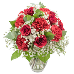 A striking red and white bouquet is captured in sharp detail against a spotless white background, creating a clean, modern portrait of classic romance. Deep red roses form the visual focal point, their petals tightly curled into elegant spirals that suggest a love still unfolding. Around them, crimson red carnations contribute generous volume and a plush, textured surface, each bloom formed from countless soft, ruffled petals that look almost feathery to the touch. Threaded through this sea of red is a light mist of white baby's breath, its countless miniature flowers gathering in clouds that soften the intensity of the darker tones and bring a feeling of purity and tenderness. Rich green foliage, including slender rose leaves and rounded eucalyptus with their muted silvery-green sheen, breaks up the reds and whites and introduces a naturally soothing contrast, much like the pockets of green you see around Queensbury Station and the nearby residential streets. All of this is gathered into a rounded, well-balanced arrangement that sits neatly in a clear glass vase, the stems visible through the water, aligned with the precision of an experienced florist. The vase's simple, slightly flared rim keeps attention on the blooms, while the bright, even lighting highlights every detail, from the subtle veining in the leaves to the layered curves of each rose. This bouquet feels both joyful and intimate, ideal for celebrating an anniversary dinner at home, sending love from afar, or marking a milestone for someone special in Queensbury with a same-day flower delivery.