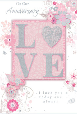 The image presents a refined anniversary card designed in a gentle palette of blush pinks, pearly whites, and misty greys, evoking the soft romance of an evening stroll through Queensbury's tree-lined avenues. At the centre of the card, the word "LOVE" stands proudly in raised letters, coated with a dusting of fine glitter that shifts between silver and pale rose as the light moves across it. Each letter appears slightly cushioned, creating a tactile, almost fabric-like surface that invites touch, echoing the feel of a luxury gift wrap or a carefully ribboned bouquet. Around this central motif swirls an arrangement of delicate, stylised flowers and flowing vines, drawn with precise, graceful lines in shades of blush, ivory, and shimmering silver foil. The blossoms curve gently around the word, much like a florist in Queensbury might cradle roses and lilies around a central focal bloom when designing a romantic anniversary display. The background is a soft pink field, subtly textured and gently shaded so that the centre glows a little lighter, drawing the eye inward. In an elegant, flowing script, short, sincere anniversary messages are printed, their understated grey ink pairing beautifully with the muted colour scheme. The mood of the card is tranquil and heartfelt, suggesting years of shared comfort and quiet joy. It feels like a paper reflection of a hand-delivered arrangement arriving at a home near Kingsbury or along Church Lane-thoughtful, tender, and meant to be cherished long after the day has passed.