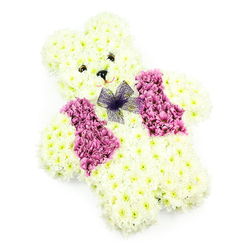 A tender floral teddy bear, crafted as a funeral tribute, is presented against a crisp white background, its design full of quiet emotion and careful detail. The entire bear is formed from tightly packed, creamy white chrysanthemums, each bloom positioned so closely that the surface takes on the look of a soft, plush toy. The rounded head, small curved ears, plump belly, and steady little paws are all shaped from these feathery petals, giving the figure a cuddly silhouette that feels both innocent and protective. Two dark, bead-like eyes sit symmetrically on the bear's face, offering a gentle, almost thoughtful expression, while a neat black nose and a suggestion of a light pink smile soften the features into something tender and reassuring. Draped across the front is a pretty floral waistcoat, created from clusters of soft purple and mauve hydrangea blossoms, their layered petals adding a velvety richness and a touch of playful colour. At the neckline, a sheer violet net bow is tied with care, its delicate folds catching the light and lending a sense of ceremony and love. The neutral white backdrop keeps all attention on the floral craftsmanship, with soft lighting bringing out the creamy tones of the chrysanthemums and the cool lilac shades of the hydrangea. Designed by a skilled florist serving families in Queensbury and the surrounding streets off Honeypot Lane, this teddy bear arrangement is often chosen for children's funerals or as a comforting tribute at local remembrance services, offering a symbol of care, warmth, and everlasting affection.