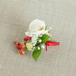 This compact boutonniere centres on a pristine white phalaenopsis orchid, its broad, almost porcelain-like petals arcing open to expose a gentle yellow-orange throat that feels both intimate and refined. Encircling the orchid are delicate sprays of gypsophila-baby's breath-whose tiny, cloud-like blooms soften the composition and lend a romantic, breathy texture. Among them, clusters of red hypericum berries sit like bright little notes, their glossy skins offering a festive, tactile contrast to the orchid's smoothness. Slim, pale green buds are tucked in as accents, hinting at newness and the quiet promise of bloom, while substantial green leaves with a soft sheen cradle the arrangement and provide a reassuring visual anchor. The stems are tied with a rich red satin ribbon, knotted simply and trimmed with a short tail to the right, the ribbon's lustre echoing the berries and adding a touch of ceremony. The boutonniere is photographed on a light beige, woven fabric-linen or burlap-with a faint texture that reads as warm and organic under soft, diffused light. From my florist's perspective in Queensbury, I imagine this piece accompanying a groom walking past Queensbury station or pinned for a guest attending a celebration near Kingsbury, its restrained palette of white, green and red making it an elegant choice for formal occasions where the details are meant to be felt rather than shouted.