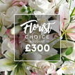 From a softly lit close-up, a Florist Choice Bouquet commands the frame, a celebration of pure white and pale pink that feels like a quiet, congratulatory gesture. The arrangement foregrounds pristine white roses in various stages of bloom, gently nestled among immaculate white lilies whose inner petals hint at blush. Intertwined among these are delicate clusters of tiny pink blossoms and soft green foliage-eucalyptus leaves that lend texture and a fresh, herbal scent to the composition. The image captures the bouquet filling the entire frame, as if you could reach out and cradle the weight of its petals. A white rectangular overlay sits centrally, its clean edge drawing the eye to the labelling: Florist in a graceful script, followed by CHOICE in a crisp sans serif, then ? BOUQUET ? and the bold ?300 beneath. This is a high-end, professionally curated arrangement, offered by a local London floristry with a deep respect for freshness and craft. In Queensbury, such a bouquet would be a thoughtful gift for anniversaries, celebrations, or a comforting gesture, available for same-day delivery across Queensbury and surrounding streets. The soft lighting enhances the satin sheen on rose petals and the porcelain glow of lilies, while the greenery adds depth and a sense of natural abundance. It's the kind of bouquet that speaks of elegant restraint, quiet luxury, and the care that comes from a skilled hand in our community.