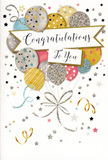 The photograph presents a stylish congratulations card that captures the essence of a joyful yet polished celebration, the kind you might find accompanying fresh flowers in a Queensbury living room. At the heart of the design is a whimsical bouquet of illustrated balloons, clustered together to form an airy focal point. The balloons are rendered in a palette of gold, silver, champagne, sky blue, soft pink, and muted grey, each one decorated with delicate patterns: tiny scattered stars, subtle glitter, or fine metallic stripes that suggest a gentle sparkle when they catch the light. Their strings descend in looping, calligraphic lines of gold and silver, tying into an elegant knot that visually anchors the floating shapes. Surrounding the balloon bouquet, small star motifs, confetti dots, and curly ribbon designs drift across a pale background, evoking the feeling of confetti caught in a light breeze after a heartfelt toast. Cutting gracefully across the middle of the card is a banner, slightly curved and softly edged, bearing the message Congratulations To You in flowing, handwritten-style script. The lettering feels warm and sincere, like a personal note from a close friend. The entire composition is spacious and harmonious, with no harsh colours or sharp contrasts-just a calm, celebratory glow. It suggests a card chosen thoughtfully to sit beside a bouquet for milestones like graduations, engagement announcements, or first homes in and around Queensbury, offering a quiet but unmistakable expression of pride and happiness.