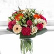 This bouquet encapsulates a joyful celebration, brought to life with bursts of vibrant colour and thoughtful design by the expert hands at Flower Delivery Queensbury. Spirited orange gerberas radiate sunny warmth, harmoniously paired with blushing pink roses and the deep, plush textures of magenta carnations. Creamy ivory roses and gentle peach gerberas lend a touch of elegance and softness, their subtle beauty brightening the overall composition. A lush halo of glossy greens ties the whole arrangement together, framing the blooms with lush abundance reminiscent of the well-kept neighbourhood gardens in Queensbury. Bathed in a gentle, almost ethereal daylight, the intricate veins of each petal are revealed, causing the bouquet's hues to shimmer as if caught in a fleeting Queensbury sunrise. Crafted for special milestones or simply to bring a moment of happiness to a loved one's day, this arrangement is a genuine burst of local artistry-a perfect mirror of the warmth and harmony cherished within the Queensbury community.