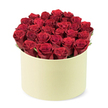 From the Queensbury studio of a local florist, this luxurious arrangement showcases deep red roses-approximately two dozen or more-whose velvety petals are tightly furled in prime bloom. They are gathered into a round, pale cream-colored cylindrical hat-box with a smooth matte finish, a refined stage for the flowers to speak. The blooms fill the container completely, rising into a dense dome that just clears the rim, while slender wisps of dark green foliage peek between the heads, adding a natural contrast and a breath of garden freshness. The scene is captured from a slightly elevated three-quarter angle against a clean white background, letting the colour and packaging take centre stage. The scent is heady and romantic, a pure rose fragrance that seems to linger like a gentle kiss in the air. This combination of creamy box and radiant crimson petals signals luxury and thoughtful gifting-perfect for anniversaries, Valentine's surprises, or special moments you want to mark with quiet grandeur. Each petal, sanded to perfection by hand, reveals the florist's craft and attention to detail. In Queensbury, it's a trusted choice for same-day delivery to homes along the High Street, near the tube station, or to quiet residential streets beyond. The arrangement speaks of romance and refinement, a sophisticated expression of love that stays fresh and vibrant for days, making it an ideal feature image for articles on luxury flower delivery or premium romantic bouquets in our part of London.