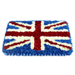A large, rectangular Union Jack funeral tribute dominates the image, its familiar pattern recreated entirely in rich, densely packed flowers that give the piece a soft yet stately presence. The base layer is composed of deep blue chrysanthemums, forming a smooth, velvety field that recalls the calm evening hues over Queensbury's tree-lined avenues. Over this backdrop, lines of crisp white chrysanthemums map out the bold vertical and horizontal cross of St George, their rounded petals creating clean, luminous pathways across the arrangement. Threaded diagonally between these, velvety red carnations depict St Patrick's Cross, each ruby stripe edged with a narrow border of white blooms so the distinctive Union Flag design remains clear and balanced. The flowers are arranged so closely that they form a slightly domed surface, almost like a floral cushion, adding depth and allowing light to play gently across the petals. A pleated, satin-like blue ribbon runs along the bottom edge, its smooth folds offering a neat, ceremonial finish similar to the formal touches seen at remembrance gatherings near Queensbury's war memorials. Even without scent, one can imagine the gentle freshness of newly cut stems and the quiet hum of a local florist's studio as this tribute is prepared. The mood it conveys is one of respect, gratitude, and quiet pride, making it a fitting choice for families in Queensbury seeking to honour a loved one's British heritage, especially for military funerals, patriotic services, or commemorative farewells.