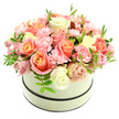 Soft as a morning blush, this luxurious floral composition sits crowned in a round, cream-coloured hatbox with two slender, dark bands-one neat rim and one at the base-set against a pure white background so every petal reads clearly. The arrangement forms a dense, domed bouquet: large, velvety roses take centre stage with warm coral-peach and apricot hues radiating from their hearts into delicate blush pink and creamy ivory outer petals, while smaller frilly baby-pink carnations nestle between them, their ruffled edges catching the soft studio light. Sparing sprigs of bright green foliage, with narrow, elongated leaves, peek through the blossoms and give the composition a fresh, airy lift like a breath of garden-scented air after rain. The texture is sumptuous-petals layered and overlapping so that some blooms are fully open, others curled as tender buds, promising continued bloom in the days to come. The tonal harmony of peach, candy-pink and cream feels both romantic and quietly celebratory, suited to an anniversary, a birthday, or to brighten a bedside or mantel. The overall impression is artisanal and intimate: a florist's careful hand has achieved a balanced, overflowing form that is at once abundant and refined. Imagine setting this atop a kitchen table in Queensbury near the station, where the gentle fragrance of roses and the powdery, sweet note of carnations would drift through a morning window, offering a moment of calm and affection to start the day.