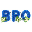 An eye-level studio photograph set against a pure white backdrop shows a three-piece, three-dimensional floral tribute spelling BRO in bold capital letters. Each freestanding character - B, R and O - is densely covered in royal blue chrysanthemum blooms, the petals tightly packed to create a plush, velvet-like surface and crisp, clean edges. At the base of each letter a small spray of pale ivory or soft yellow spray roses nestles among tiny white filler flowers, likely mini chrysanthemums or baby's breath, their gentle buds and half-open blooms softening the strong blue. Lush green foliage - broader glossy leaves reminiscent of salal or lemon leaf and finer, feathery fern fronds - is woven through the accents to add depth, subtle scent and a cool, natural contrast. A slim white support frame or foam base is visible along the letter contours and inside the loops of B and R and the O's centre, hinting at the careful workmanship that holds the design upright for viewing at a memorial. Soft, neutral studio lighting illuminates the textures and the slight sheen on the foliage while keeping the mood reverent and composed. The palette of royal blue with cream and white accents reads as a quiet statement of remembrance and loyalty, suited to a brother or close friend. As a local florist familiar with Queensbury and neighbouring Kingsbury and Wembley, I picture this tribute arriving at chapels or wakes across the area, its serene colours offering a dignified, personal expression of condolence and memory.