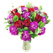 A lush, hand-gathered bouquet of deep red roses and magenta-purple carnations sits in a simple clear glass vase against a crisp white backdrop, described here as if speaking to a neighbour from Queensbury. In soft studio light the roses range from tightly furled buds to gently unfurling blooms, their velvety crimson spirals catching highlights along the petal edges and giving a quiet sense of timeless romance. Interspersed among them are ruffled carnations in a vivid fuchsia-purple, their densely layered, almost feather-like petals creating a lively contrast of texture and colour that lifts the composition. Bright, glossy green leaves-think ruscus or similar-form a full, verdant cradle for the flowers, while slender sprigs of silvery eucalyptus thread through the arrangement and introduce a fresh, airy counterpoint. The clear vase keeps the stems visible, adding an honest, natural quality that suggests the bouquet was assembled moments ago with locally sourced blooms. The white background makes the reds and purples sing, and you can almost sense the subtle, sweet perfume where rose rounds meet the faintly spicy note of carnation and the cooling citrus of eucalyptus. Perfect for an anniversary, birthday, or a thoughtful delivery to a friend near Queensbury Station or a table set after a walk in Fryent Country Park, this arrangement reads as both celebratory and sincere. A local florist's careful hand is evident in the rounded, generous shape and balanced rhythm of colour and leaf-an elegant, tactile bouquet that feels like a personal message of warmth and care to someone in the Queensbury neighbourhood.