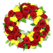 A meticulously crafted circular funeral wreath of red and yellow flowers is captured against a bright white background, the arrangement appearing both lush and carefully controlled, as though just finished by a skilled Queensbury florist. The wreath is densely woven with deep red roses, each bloom fully open yet perfectly shaped, their velvety petals spiralling inward in smooth layers that range from classic crimson around the edges to richer, darker tones toward the centre. Nestled between these roses are numerous yellow chrysanthemums, their many thin, delicate petals forming rounded cushions of colour that contrast softly with the smooth rose petals. Some of the yellow blooms appear slightly lighter or deeper in tone, giving the wreath a natural, garden-like variation instead of a flat, uniform look. Beneath and around the flowers, a generous layer of mixed greenery creates volume and structure: broad, vivid green leaves, likely salal or similar foliage, provide a strong, glossy base, while more subtle, grey-green sprigs with a matte finish-reminiscent of eucalyptus-add textural interest and a sense of natural calm. The flowers and foliage are arranged tightly to form a perfectly symmetrical ring with a clear, open centre, symbolising continuity, devotion, and the circle of life. The white studio background and even lighting intensify the colours, making the red roses appear especially rich and the yellow chrysanthemums almost luminous. This wreath would look at home resting beside a framed photograph at a memorial gathering or laid gently at a graveside in Queensbury, perhaps after a farewell service near Queensbury tube, offering a visual message of love, remembrance, and quiet comfort.