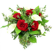 A striking mixed bouquet of red roses and white calla lilies is displayed in a simple clear glass vase, photographed against an all-white background that throws every colour and line into sharp focus. At the core of the arrangement, several red roses open fully, their petals velvety and lush, spiralling from tight centres into generous blooms saturated in deep crimson. Nestled among them, tall calla lilies rise with poised elegance, their smooth, creamy white petals forming graceful trumpets that curl gently at the edges, each bloom wrapped around a soft golden spadix that peeks from within. The flowers are embraced by a rich collar of greenery: airy eucalyptus with rounded, silvery-green leaves offers a fine, textured contrast, while larger, darker leaves spread out to form a vivid green backdrop that frames the red and white perfectly. The cylindrical glass vase reveals tidy, green stems and sparkling clear water, with a discreet ribbed ring near the base giving a hint of decorative detail without distracting from the blooms. Bright, even light floods the scene, emphasizing the natural sheen of the foliage and the plush surface of each rose petal, giving the whole display a freshly arranged, celebratory feel. This is the kind of bouquet a Queensbury local might have delivered to a home near Canons Park or a restaurant off Springfield Lane, its romantic palette and balanced design ideal for anniversaries, proposals, or simply adding a sophisticated touch to an intimate dinner at home.