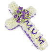 A tender, cross-shaped funeral tribute formed from a dense carpet of pure white chrysanthemums, photographed against a bright, clinical white background so every petal and contour reads clearly. The body of the cross feels soft to the touch in the mind's eye-each chrysanthemum head tightly placed to create a pillowy, seamless surface that symbolizes purity and repose. Along the full outer edge, a ruffled purple satin ribbon is carefully pleated and woven as a border, its slight sheen catching soft studio light and lending a quiet, dignified frame to the arrangement. On the vertical arm the letters MUM are lovingly composed from small, rich purple flower heads-likely eustoma or spray chrysanthemums-each letter raised just enough to read clearly against the white field and to make the dedication unmistakeable. Anchoring the centre where the arms meet is a generous, lush spray: deep violet roses with velvety petals, paler lavender lisianthus or eustoma, and small pockets of variegated green foliage whose lighter margins and darker centres add sculptural depth. Scattered green berries and slender foliage stems give texture and life amid the cool purples. The bouquet's gentle fragrance suggests cut roses and fresh green leaves, a calm scent appropriate to a funeral chapel or graveside. As a Queensbury florist I picture this tribute respectfully placed near the altar or family pews in services around Queensbury, Kingsbury and Colindale, offering a composed, heartfelt expression of sorrow and enduring love.