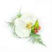 A delicate white Phalaenopsis orchid sits at the heart of this elegant boutonniere or wrist corsage, its broad, satiny petals unfolding like soft porcelain under morning light. The orchid's throat reveals whispering tones of pale yellow, warm gold and a hint of light brown, lending a tender depth to the blossom's pristine white surface. Fine, feathery sprays of asparagus fern arch gently to the left and cascade down to the right, their pale green filigree creating a misty, tactile frame that feels cool and dewy to the touch. On the right, clusters of small, rounded reddish-pink hypericum berries introduce a warm, garden-fresh punctuation; they catch the eye with a glossy sheen and suggest a faint, earthy scent behind the orchid's clean perfume. Nestled near them, a compact, lime-green chrysanthemum or verdant filler adds a cheerful pop of chartreuse texture, its tightly packed petals offering a pleasing contrast to the orchid's broad planes. The arrangement is compact yet airy, intentionally asymmetrical so it reads beautifully on a lapel or as a wrist piece without feeling rigid-an artisan's study in balance and restraint. Photographed against a crisp white background, every curve, vein and surface is clearly visible: the orchid's waxy softness, the fern's feathered detail, the berries' smooth roundness and the chrysanthemum's bright granularity. This piece evokes refined celebration-perfect for a wedding, prom or formal occasion-and carries a quiet sense of place, the kind of floral work I make for clients around Queensbury and nearby Fryent Country Park when they ask for something both modern and timeless.