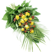 An elegant, teardrop-shaped funeral spray of yellow roses and red berries lies against a stark white background, the clarity of the setting drawing the eye to every detail of the arrangement. The spray begins with a full, rounded head of flowers and foliage at the upper left, then tapers gently down to a softer point at the lower right, creating a natural sense of flow. At its heart are approximately fifteen to twenty yellow roses, some still in tight bud and others fully open, their petals unfolding in soft, velvety layers. The yellow tones are rich yet soothing, somewhere between butter and deep gold, offering a feeling of comfort and quiet optimism. Scattered throughout are tight clusters of bright red Hypericum berries, round and glossy like tiny marbles, which stand out vividly against the yellow blooms and green leaves. The greenery is both abundant and carefully controlled. Near the top, large, dark green leaves have been expertly folded and wrapped by the florist to form a strong, sculptural base, reminiscent of the well-tended shrubs and trees that line the quieter residential streets of Queensbury. From the lower right of the spray, long, slender palm-like fronds sweep outward, each narrow leaflet adding length and a feathery lightness that balances the solid cluster of blooms above. The stems are gathered and bound neatly where the foliage converges, suggesting the piece is designed to rest flat on a coffin, stand, or graveside. Overall, the arrangement feels serene and respectful, an appropriate tribute for local memorial services, wakes, or funerals in Queensbury where families wish to express love, remembrance, and gentle support.