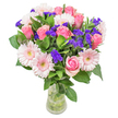 There is a delicate poetry in this arrangement, a gentle choreography of pastel pink roses and pale Gerbera daisies that seem to dance above glossy, forest-green leaves-each petal glowing softly in the filtered daylight streaming through a Queensbury window. The roses unfold their velvety layers, suffused with an affectionate blush that hints at first love, gratitude, or deep appreciation. Playful tufts of vivid violet statice nestle between the blooms, their papery texture and subtle wildflower fragrance evoking cheerful spontaneity reminiscent of early mornings in Canons Park. Together, these flowers balance fullness with airiness, as though they were freshly gathered from a sun-kissed meadow. Designed in a slender glass vase, the bouquet is an invitation to mark moments of happiness-a birthday toast, a message of congratulations, or silent reassurance when words are not enough. Each stem tells a story, selected for both beauty and meaning, ensuring that a gesture made with these blooms truly honours the recipient, while carrying with it the spirit and scenery of Queensbury's vibrant neighbourhoods.