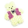 A teddy bear-shaped floral tribute, thoughtfully created for a funeral or memorial, is displayed against a plain white background where every petal stands out in gentle detail. The entire bear is composed of tightly clustered white chrysanthemums, their soft, feathery petals pressed closely together to form a plush, almost cloud-like coat. From the rounded head and neat, curved ears to the solid little paws and compact legs, the flowers are arranged to mimic the comforting shape of a much-loved soft toy. At the centre of the face, two small, dark eye details sit above a triangular black nose, giving the bear a tender, slightly wistful expression that suggests both innocence and quiet comfort. Just beneath, the faint hint of a curved, pink-tinted smile adds warmth and reassurance, as if the bear is keeping watch over treasured memories. A floral waistcoat crafted from clusters of lilac and purple hydrangea blooms lies neatly across the chest, the petals forming two side panels that frame the front of the bear and bring in a gentle wash of colour. Tied delicately at the neckline, a sheer purple net bow introduces an extra touch of charm and care, its translucent loops softening the transition between the white and lilac tones. The bright, uncluttered background and soft studio lighting allow the creamy whites and cool purples to glow quietly, highlighting the skill of the florist who shaped each curve and feature. Often chosen for children's services or as a tender tribute at local gatherings in Queensbury and nearby Kingsbury, this floral teddy bear offers a sense of warmth, solace, and enduring love.